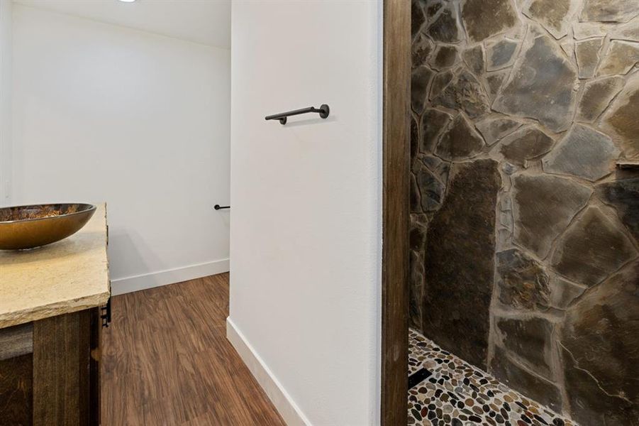 Bathroom with vanity, a shower, and hardwood / wood-style floors