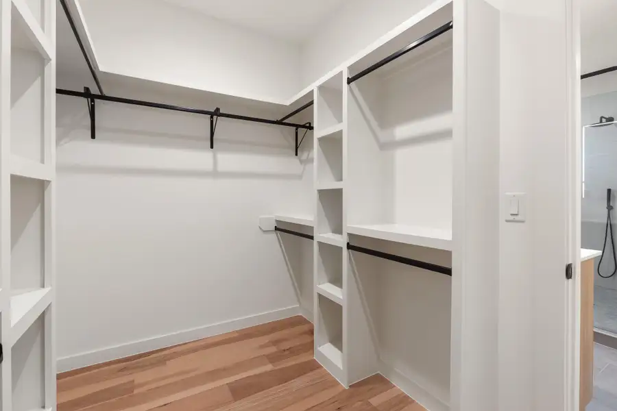 The spacious walk-in closet provides ample room for clothing, shoes, and accessories. The spacious walk-in closet provides ample room for clothing, shoes, and accessories.