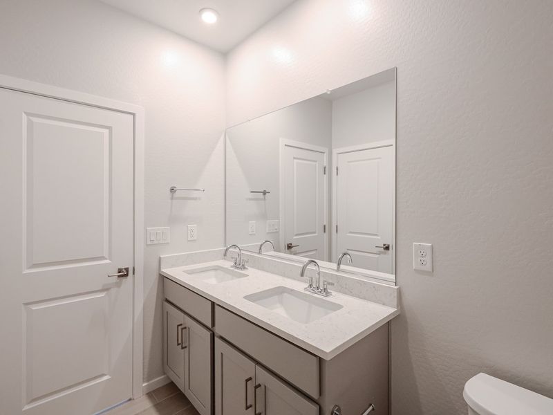 A bathroom with a large mirror.