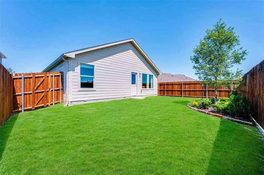 Rear view of house featuring a lawn