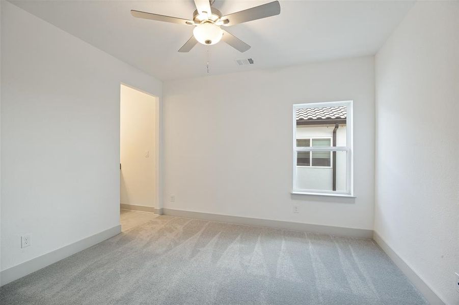 Neutral-toned room featuring a single window and recessed doorway Neutral-toned room featuring a single window and recessed doorway