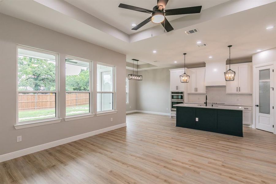 Kitchen with double oven, plenty of natural light, tasteful backsplash, and recessed lighting Kitchen with double oven, plenty of natural light, tasteful backsplash, and recessed lighting