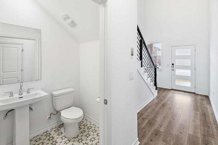 Half bath with toilet and baseboards