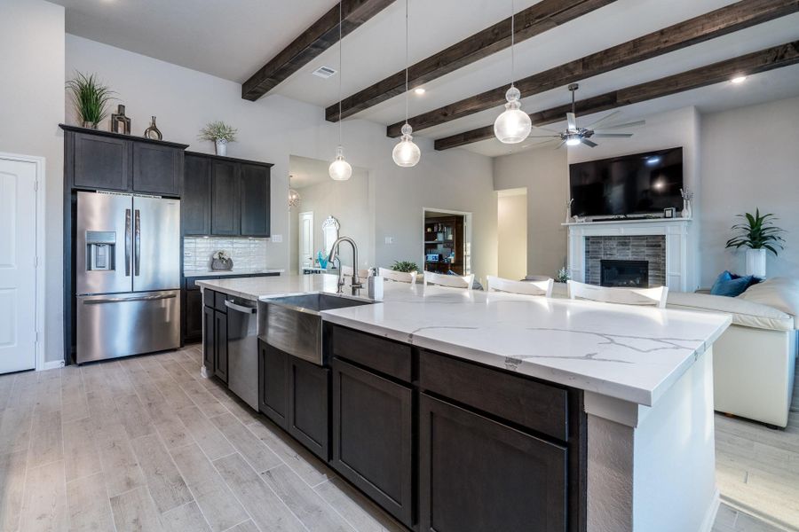 Epicurean gourmet kitchen w/upgraded GE Profile stainless steel appliances, stainless steel farmhouse sink and gleaming designer Quartz countertops.