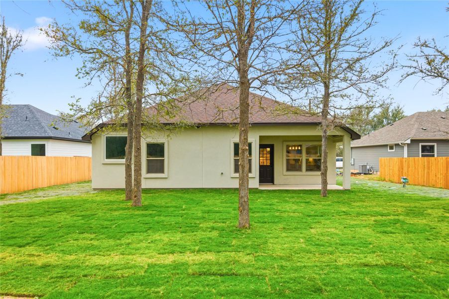 Back of house with a fenced backyard, a patio, stucco siding, and a shingled roof