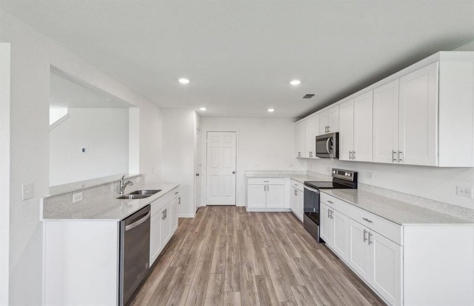 Ample cabinet space in kitchen with oversized island *real home pictured