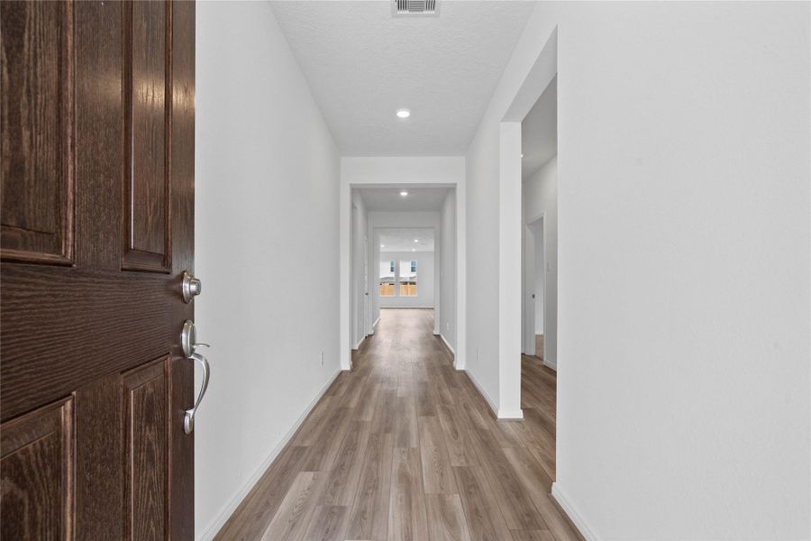 Step inside your new home, where the Layton Lake vinyl plank flooring and fresh, bright paint create a warm and inviting entryway. Step inside your new home, where the Layton Lake vinyl plank flooring and fresh, bright paint create a warm and inviting entryway.