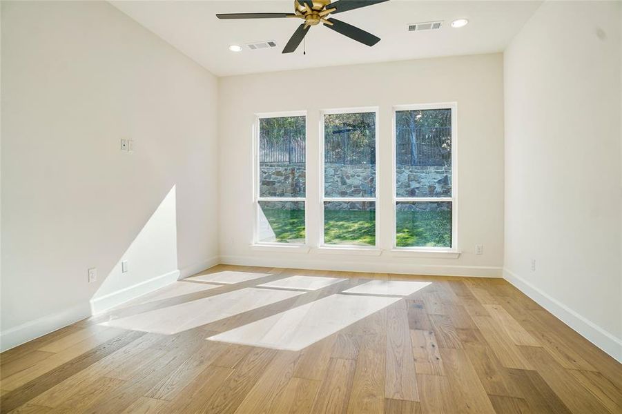 Empty room with light wood-type flooring, recessed lighting, and ceiling fan