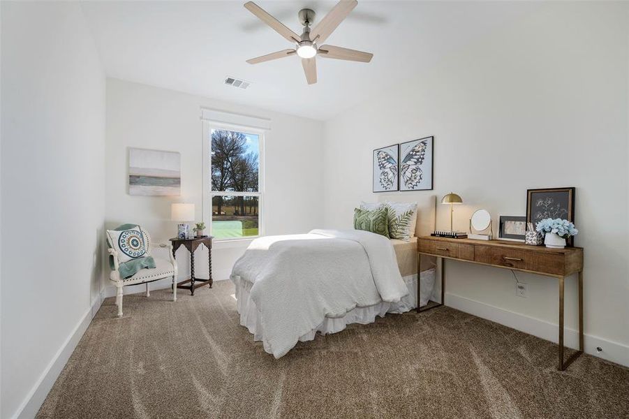 Nice sized secondary bedroom located off front of house. Featuring walk-in closet with exceptional built-ins, brand new carpet, and ceiling fan.