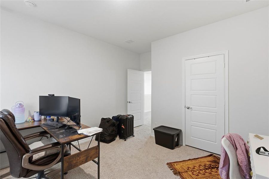Light-colored wall finishes, recessed ceiling lighting, and carpeted flooring