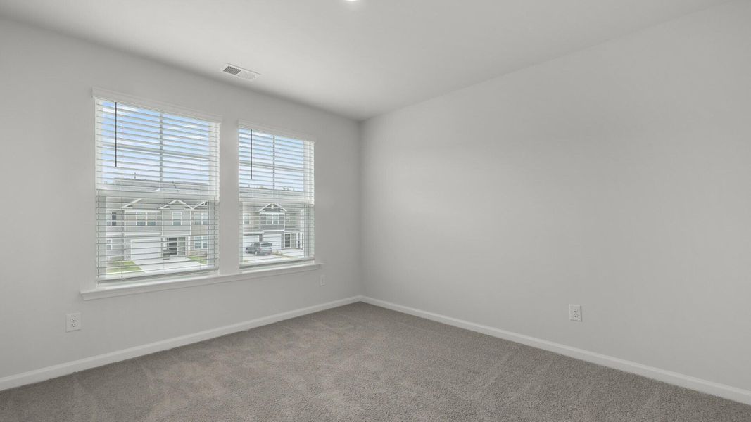 Spacious, unfurnished interior of a new home in Pine Hills Townhomes at Cane Bay, Summerville (Image 23).