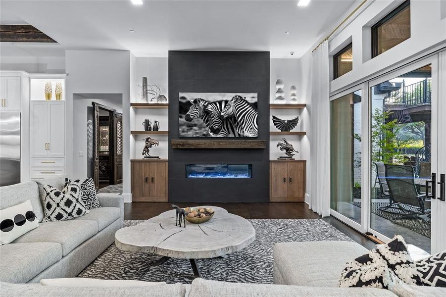 Living room with a fireplace, beam ceiling, and dark hardwood / wood-style floors