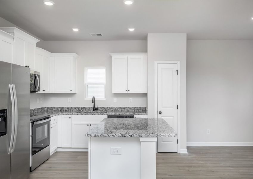 The kitchen is connected to the dining area