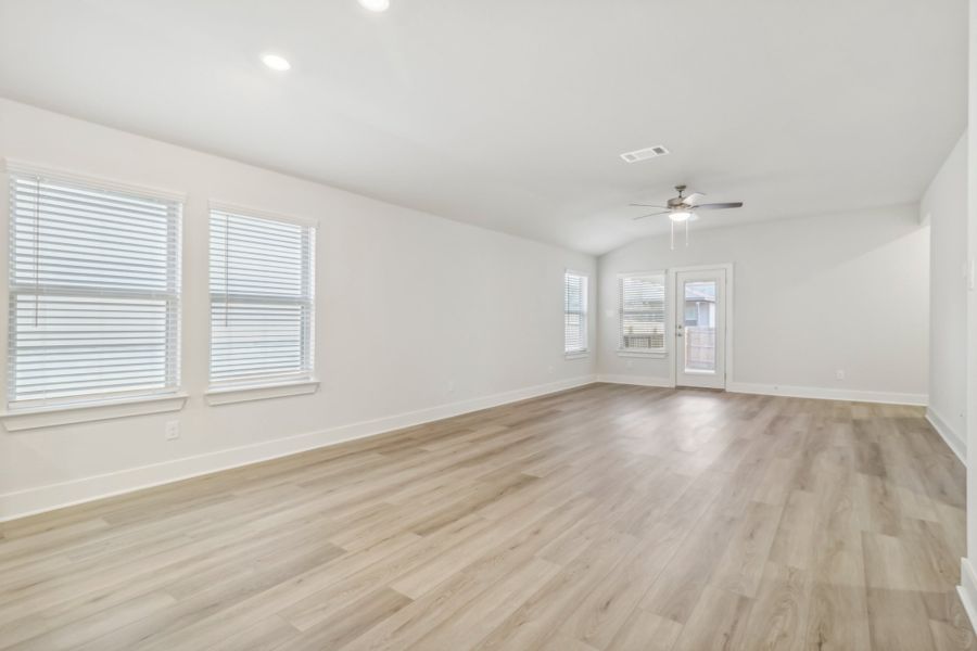 Living room and dining room in the Hughes floorplan at a Meritage Homes community.