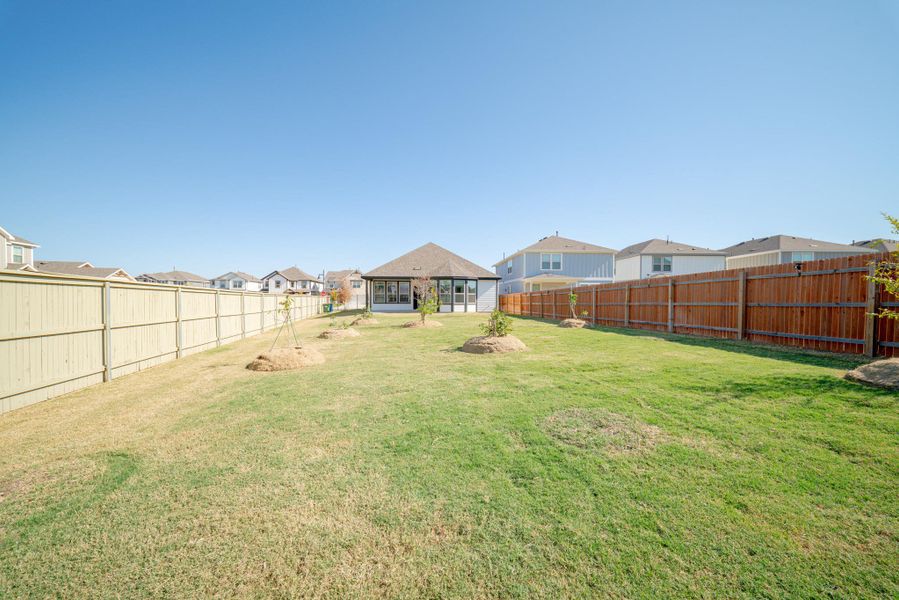 Fenced backyard featuring a residential view Fenced backyard featuring a residential view