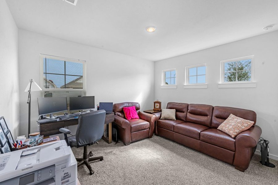 Versatile secondary bedroom currently utilized as a functional home office with great natural light.