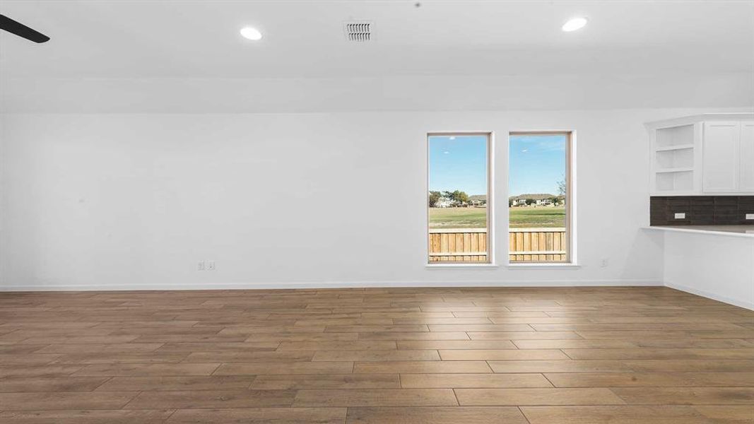 Spare room featuring wood-type flooring