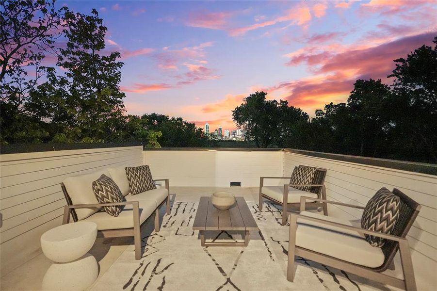 Patio terrace at dusk featuring outdoor lounge area