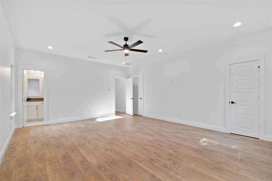 Spare room featuring ceiling fan and light wood-type flooring