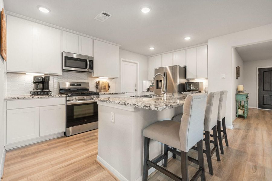 Lots of room to move around the kitchen or enjoy your morning java at the breakfast bar. The under-counter lighting is just another of the many upgrades. Lots of room to move around the kitchen or enjoy your morning java at the breakfast bar. The under-counter lighting is just another of the many upgrades.