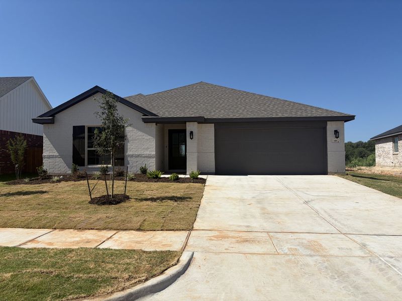 Front exterior of a new home in Stoneview, Glen Rose, TX, highlighting curb appeal (Image 1). Front exterior of a new home in Stoneview, Glen Rose, TX, highlighting curb appeal (Image 1).
