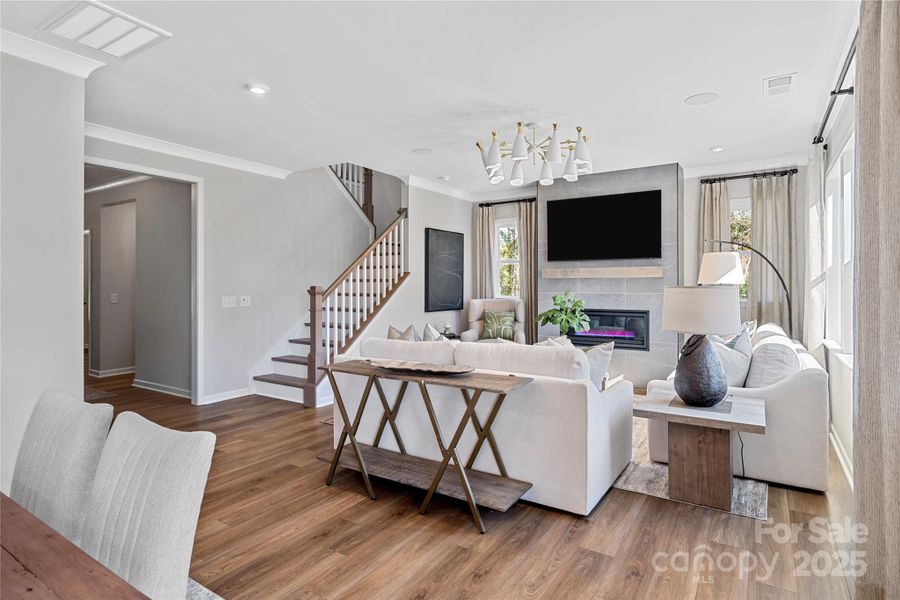 Great room featuring gas fireplace and open rail.