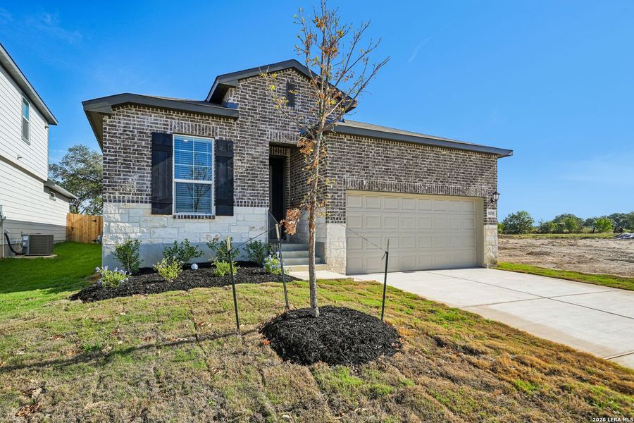 Front exterior of a new home in Thomas Pond, San Antonio, TX, highlighting curb appeal (Image 20).
