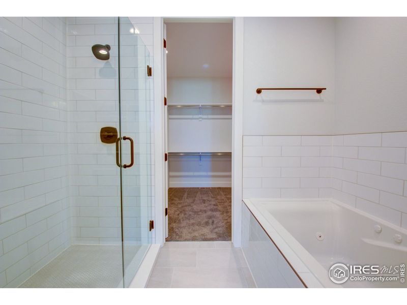 Porcelain tile flooring and full wall shower surround