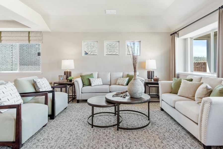Living room with two beige sofas, round coffee tables, and large windows with natural light Living room with two beige sofas, round coffee tables, and large windows with natural light
