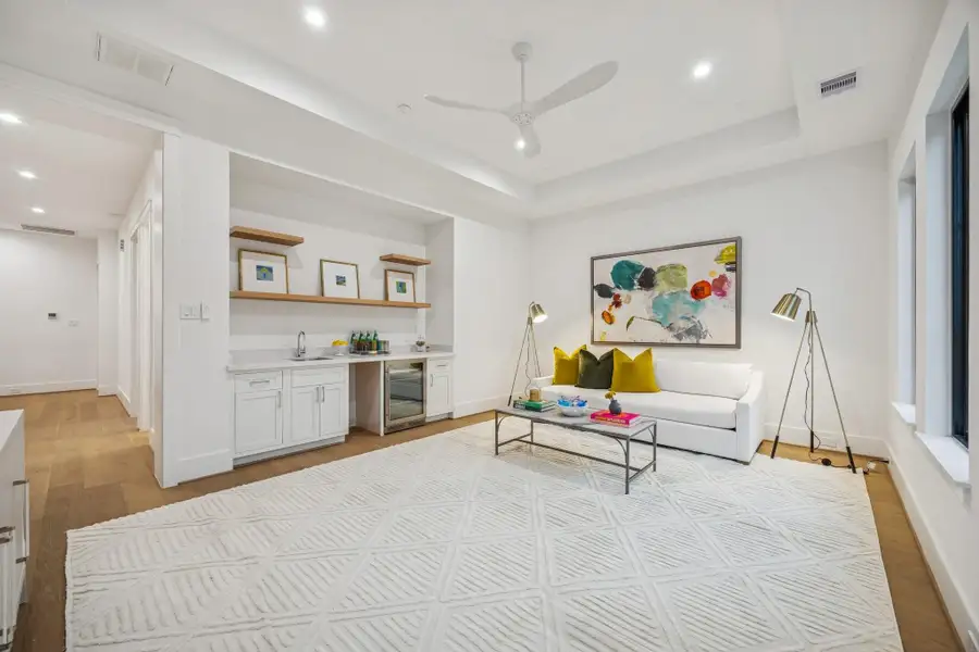 Upstairs media room with 7 1/2 Inch Wide Plank, European White Oak Floors, Coffered Ceiling and a MinkaAire Roto XL 62" 3 Blade Ceiling Fan.