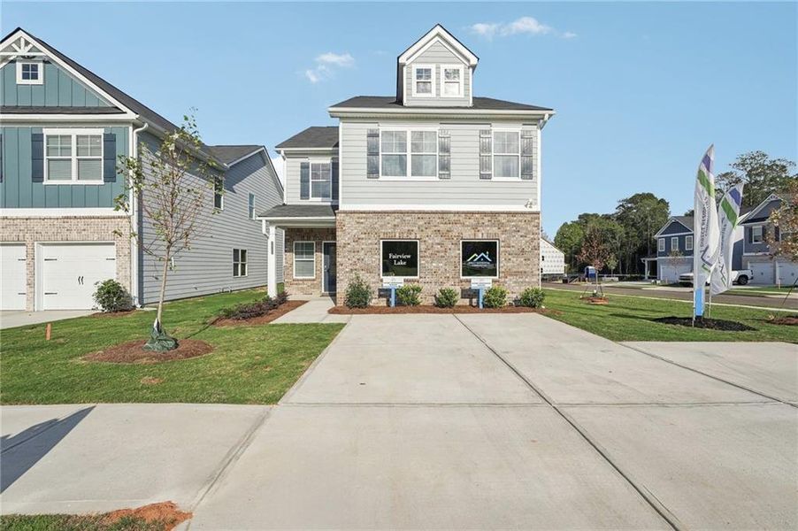 Front exterior of a new home in Vickers Point - Single Family, Fairburn, GA, highlighting curb appeal (Image 2). Front exterior of a new home in Vickers Point - Single Family, Fairburn, GA, highlighting curb appeal (Image 2).