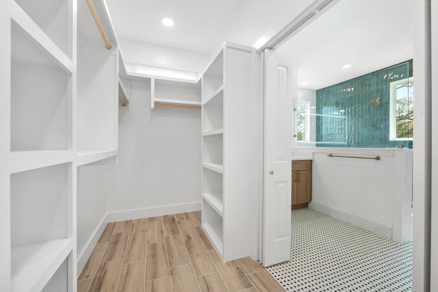 Walk in closet with wood tiled floors Walk in closet with wood tiled floors