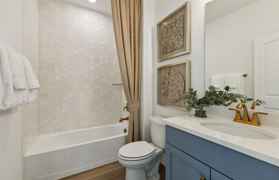 Secondary bathroom featuring modern upgrades and finishes *Model representation