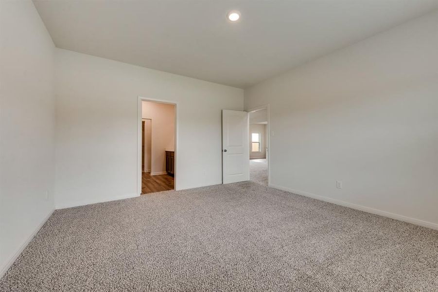 Unfurnished bedroom featuring carpet flooring and ensuite bath