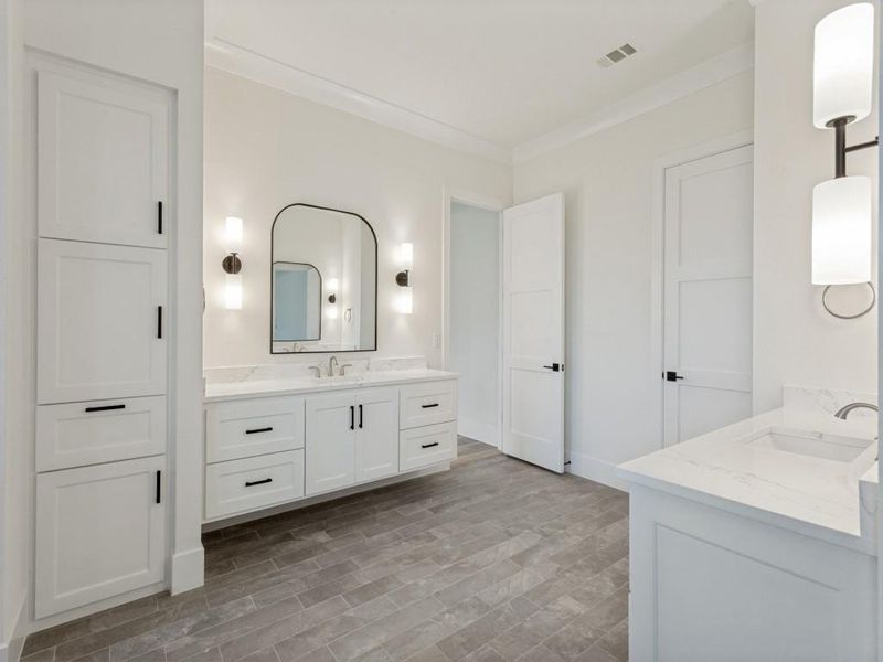 Contemporary bathroom featuring a floating double vanity with a marble-finish countertop, an arched mirror, and dual wall sconces Contemporary bathroom featuring a floating double vanity with a marble-finish countertop, an arched mirror, and dual wall sconces