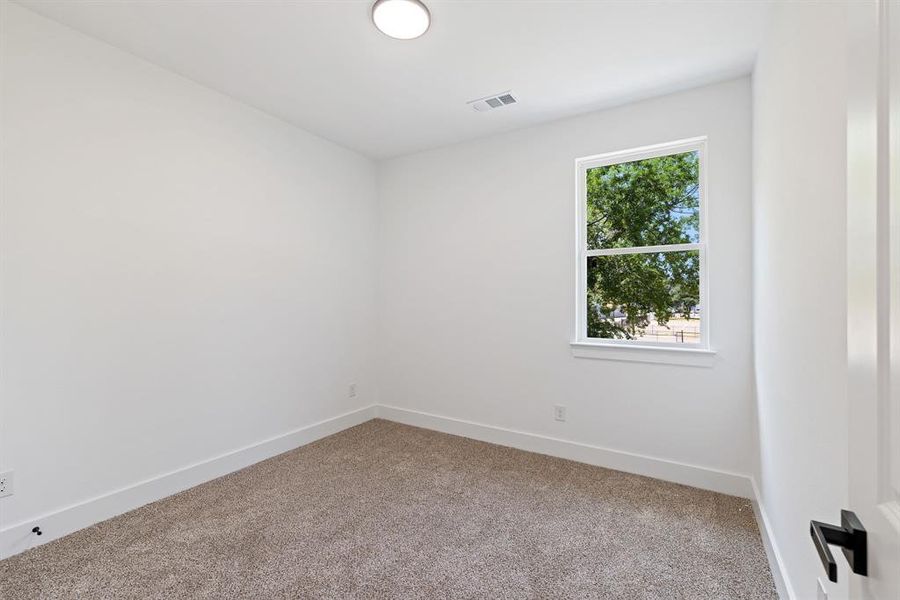 Empty room featuring baseboards and carpet flooring