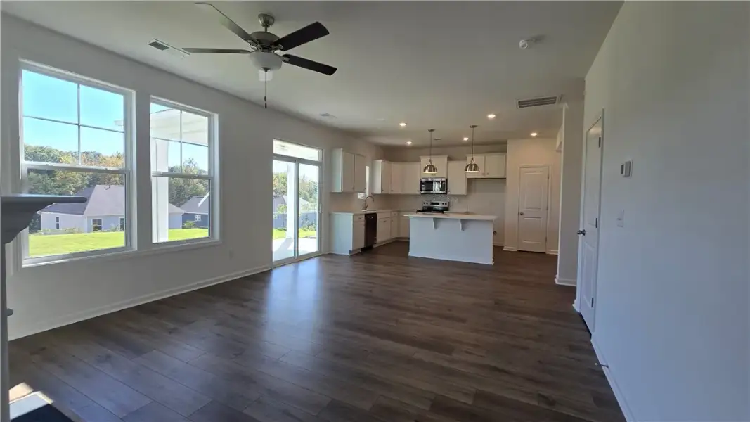 Rich wood-inspired flooring anchors a seamless flo