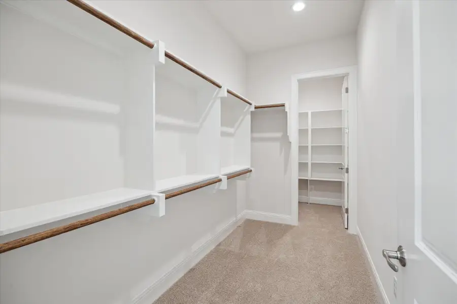 1 of 2 walk-in closets in the Primary Suite. This closet features a hidden space!