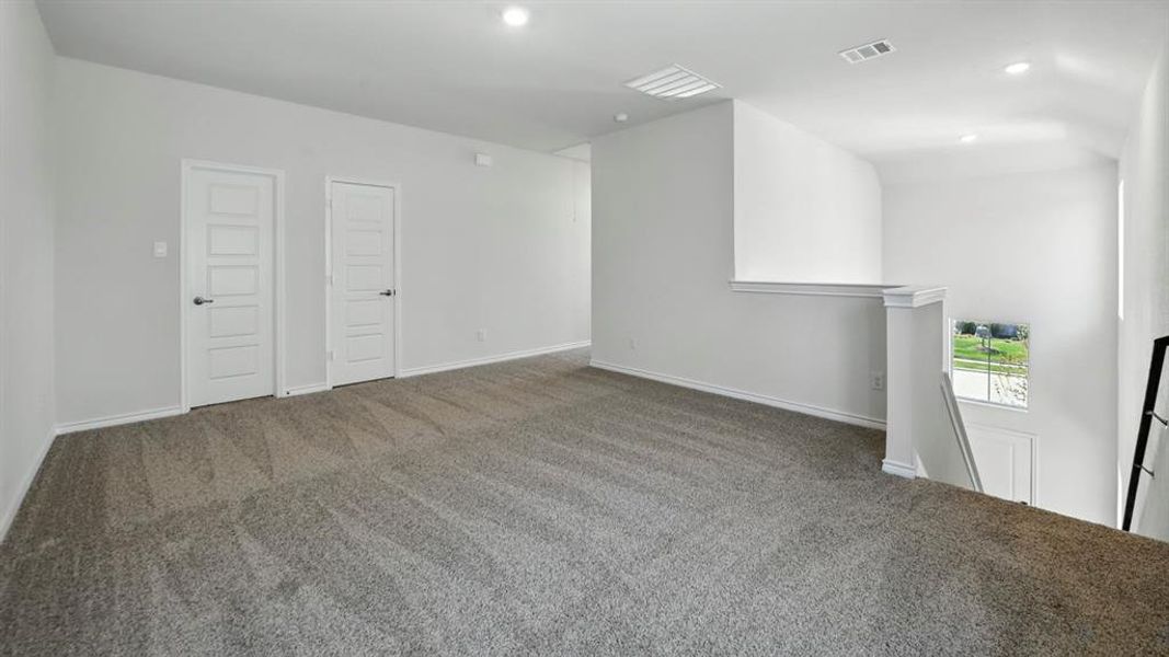 Carpeted spare room featuring recessed lighting