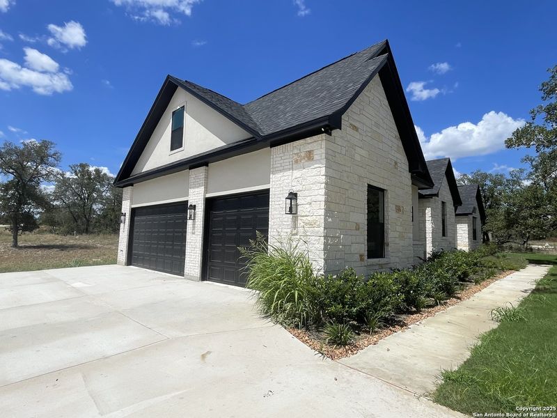 Front exterior of a new home in , Castroville, TX, highlighting curb appeal (Image 1).
