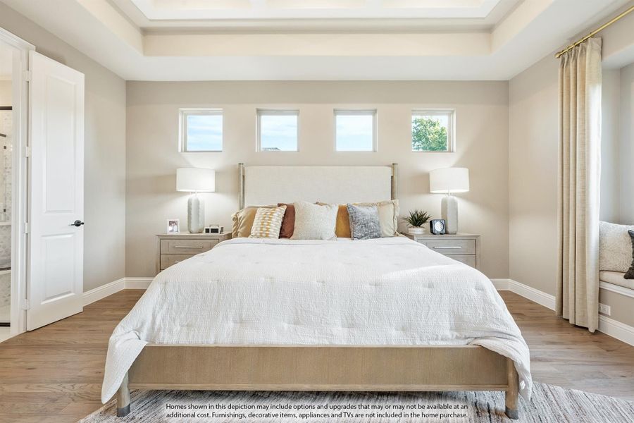 Master bedroom with tray ceiling, hardwood floors, and three small windows above the bed headboard Master bedroom with tray ceiling, hardwood floors, and three small windows above the bed headboard
