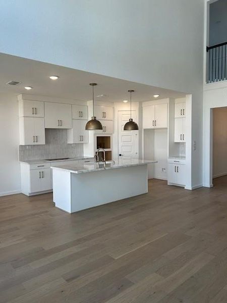 Kitchen has great appeal with white cabinetry and champagne bronze accents.Porcelain counters give that special custom feel. Kitchen has great appeal with white cabinetry and champagne bronze accents.Porcelain counters give that special custom feel.