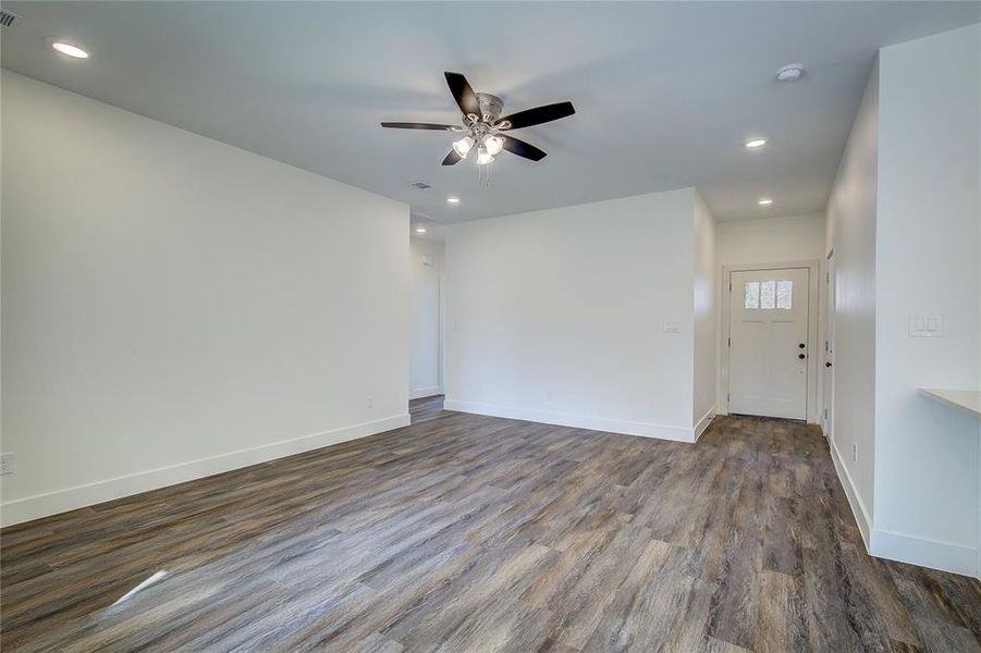 Empty room featuring recessed lighting, dark wood-style floors, and a ceiling fan Empty room featuring recessed lighting, dark wood-style floors, and a ceiling fan