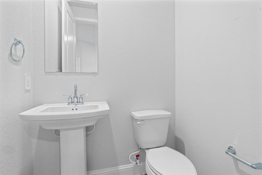 The powder bath features a stylish vanity and a clean, modern design. The powder bath features a stylish vanity and a clean, modern design.