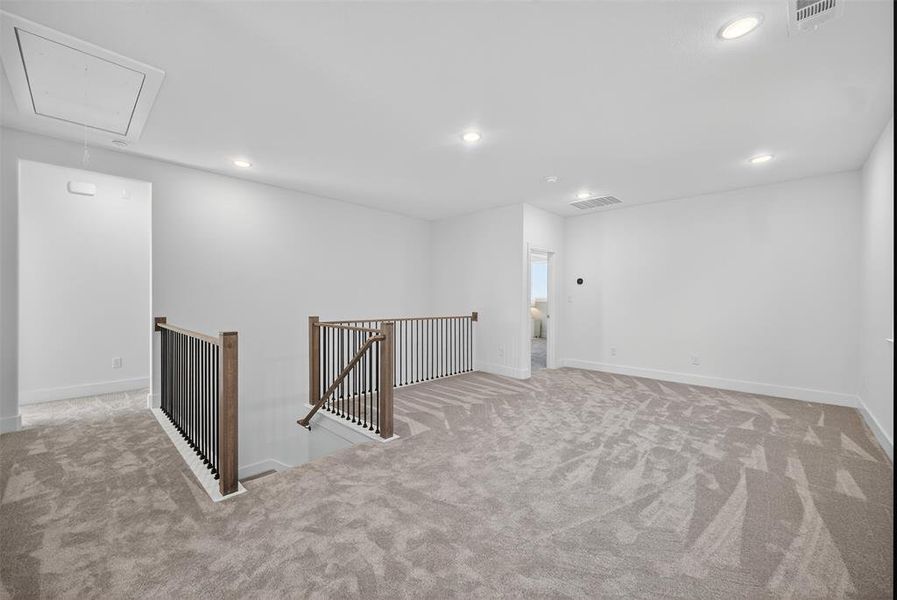 Spare room with attic access, light colored carpet, and recessed lighting Spare room with attic access, light colored carpet, and recessed lighting