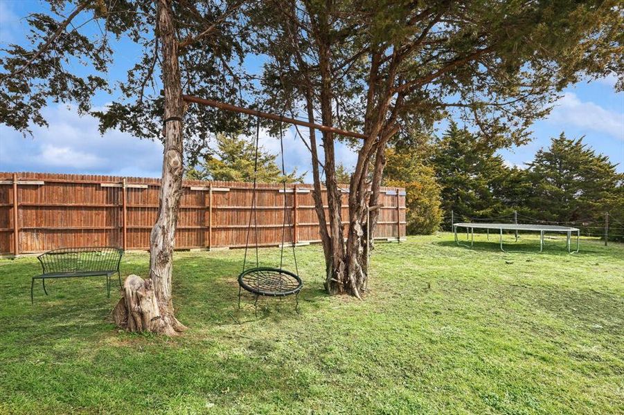 View of yard with a trampoline