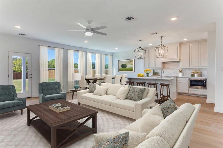 Living room featuring light wood-type flooring, a chandelier, recessed lighting, and a ceiling fan