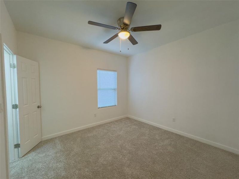 Spare room with carpet and ceiling fan