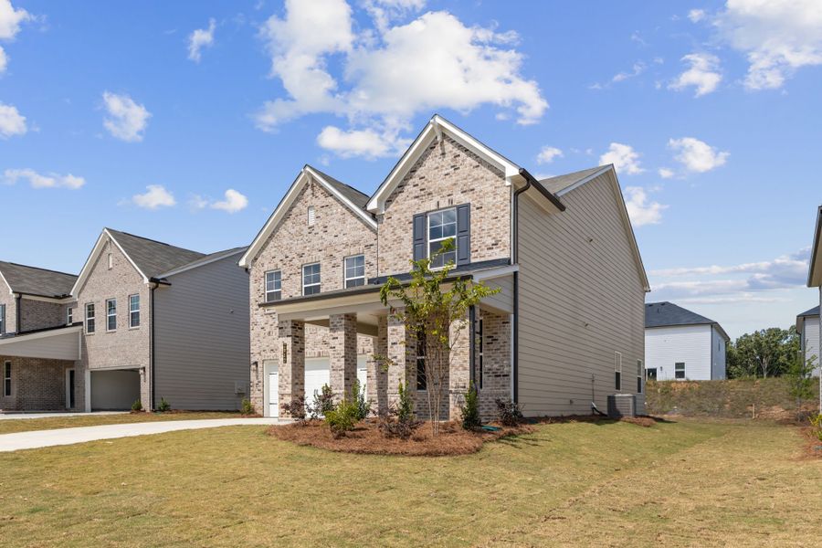 A house with a tree in the front.