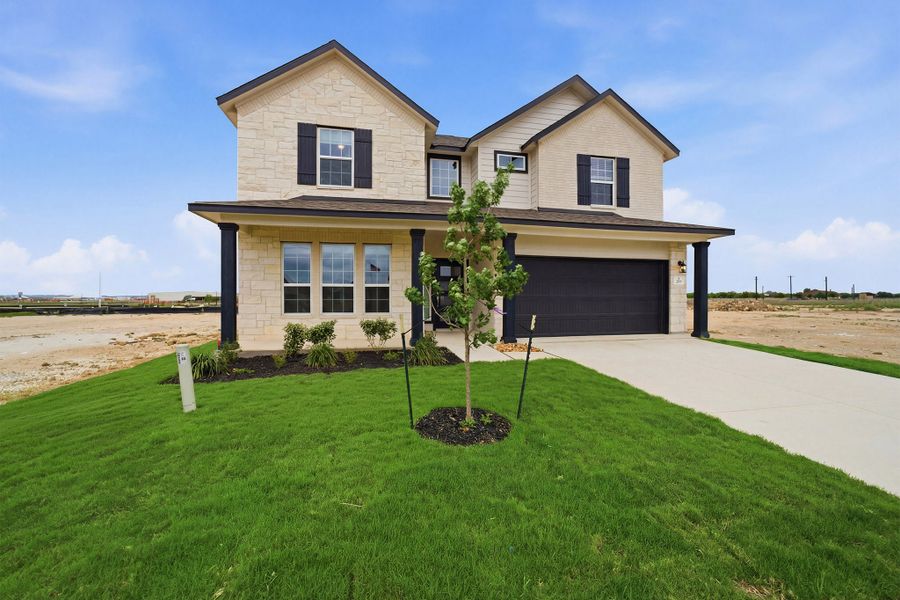 Front exterior of a new home in Megan's Landing, Castroville, TX, highlighting curb appeal (Image 22). Front exterior of a new home in Megan's Landing, Castroville, TX, highlighting curb appeal (Image 22).